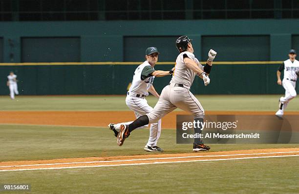 Tampa Bay Devil Rays pitcher Casey Fossum tags out Baltimore Orioles first baseman Jeff Conine on a bunt attempt in the first inning July 21, 2006 at...