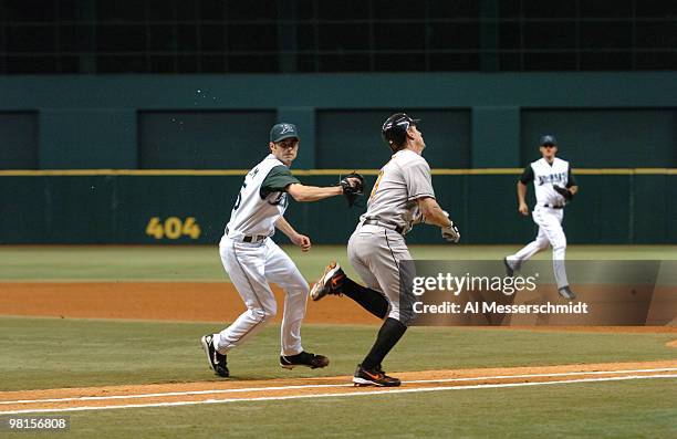 Tampa Bay Devil Rays pitcher Casey Fossum tags out Baltimore Orioles first baseman Jeff Conine on a bunt attempt in the first inning July 21, 2006 at...