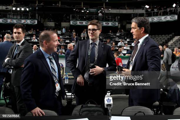John Lilley, Kyle Dubas and Brendan Shanahan of the Toronto Maple Leafs talk prior to the first round of the 2018 NHL Draft at American Airlines...