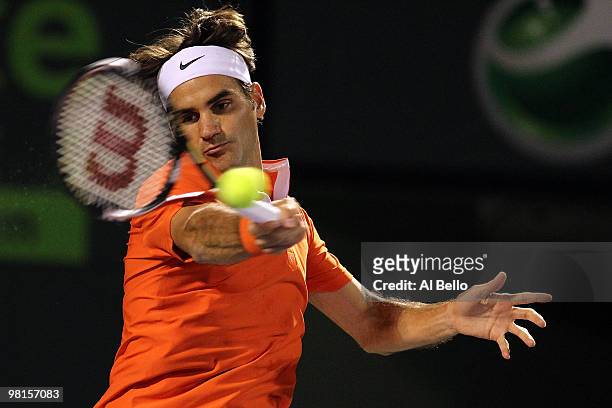 Roger Federer of Switzerland returns a shot against Tomas Berdych of the Czech Republic during day eight of the 2010 Sony Ericsson Open at Crandon...