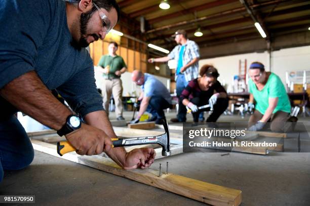 Instructor Moses Alvarez, left, teaches the finer points of building concrete forms to students taking part in the Construction Careers Now! program...