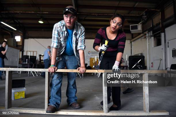 Students Andrew Parker, left, and Rafelina Garibay, right, learn how to make concrete forms during the Construction Careers Now! program at the...