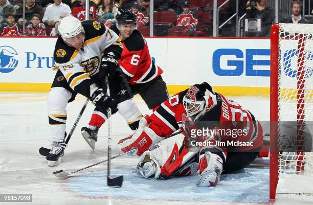 Martin Brodeur of the New Jersey Devils makes a third period save against Michael Ryder of the Boston Bruins at the Prudential Center on March 30,...