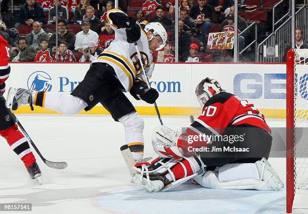 Martin Brodeur of the New Jersey Devils makes an overtime save against Mark Recchi of the Boston Bruins at the Prudential Center on March 30, 2010 in...