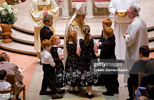Milwaukee Archbishop Jerome Listecki receives the gifts during the evening Chrism Mass at the Cathedral of St. John the Evangelist March 30, 2010 in...