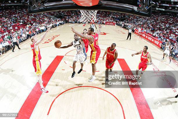 Earl Boykins of the Washington Wizards shoots the ball over Chuck Hayes of the Houston Rockets on March 30, 2010 at the Toyota Center in Houston,...