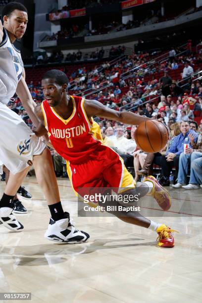 Aaron Brooks of the Houston Rockets drives the ball past JaVale McGee of the Washington Wizards on March 30, 2010 at the Toyota Center in Houston,...