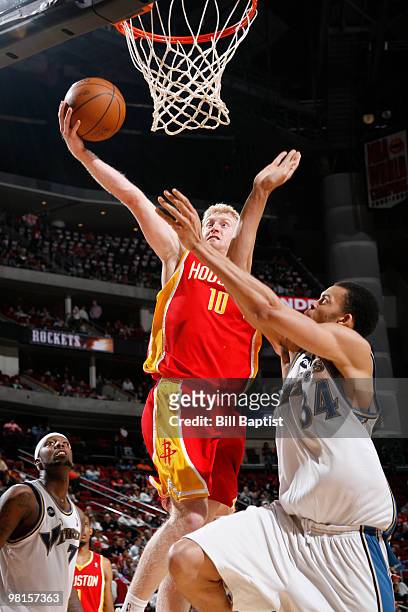 Chase Budinger of the Houston Rockets shoots the ball over JaVale McGee of the Washington Wizards on March 30, 2010 at the Toyota Center in Houston,...