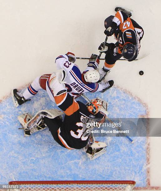 Dwayne Roloson of the New York Islanders makes the save on Chris Drury of the New York Rangers at the Nassau Coliseum on March 30, 2010 in Uniondale,...