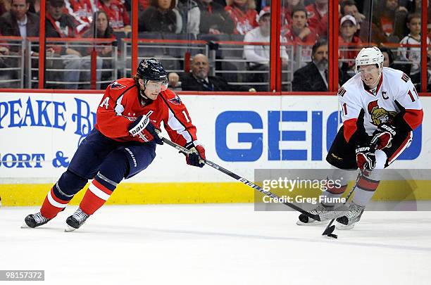 Daniel Alfredsson of the Ottawa Senators steals the puck from Tomas Fleischmann of the Washington Capitals at the Verizon Center on March 30, 2010 in...