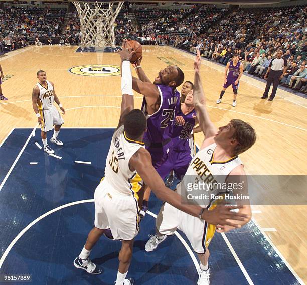 Carl Landry of the Sacramento Kings battles Roy Hibbert and Troy Murphy of the Indiana Pacers at Conseco Fieldhouse on March 30, 2010 in...