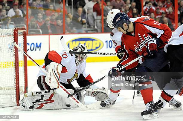 Brian Elliott of the Ottawa Senators makes a save against Matt Bradley of the Washington Capitals at the Verizon Center on March 30, 2010 in...