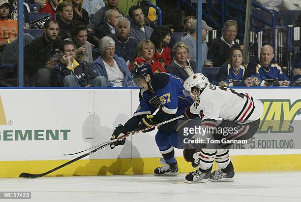 David Perron of the St. Louis Blues handles the puck as Duncan Keith of the Chicago Blackhawks defends on March 30, 2010 at Scottrade Center in St....
