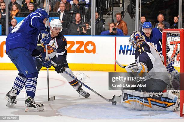 John Mitchell of the Toronto Maple Leafs battles with Ron Hainsey of the Atlanta Thrashers in front of goalie Ondrej Pavelec of the Thrashers March...