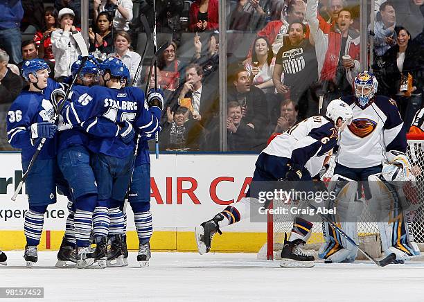 Carl Gunnarsson and Viktor Stalberg of the Toronto Maple Leafs celebrate a third-period goal with Ron Hainsey and Ondrej Pavelec of the Atlanta...