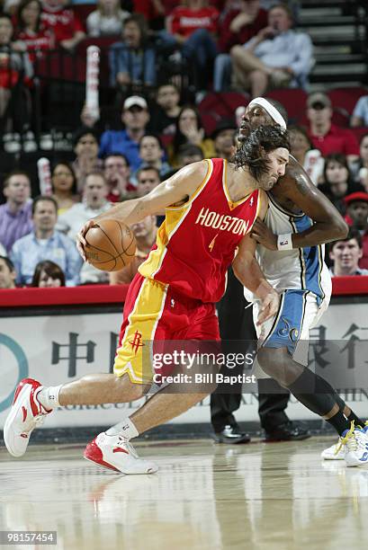 Luis Scola of the Houston Rockets drives the ball past James Singleton of the Washington Wizards on March 30, 2010 at the Toyota Center in Houston,...