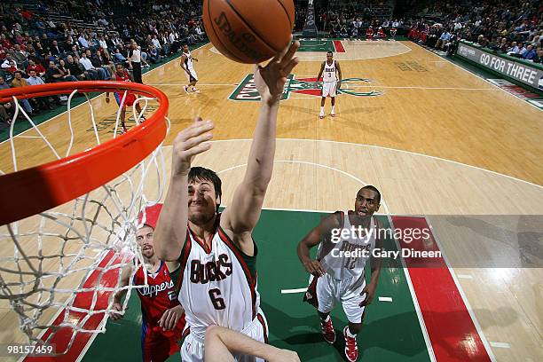 Andrew Bogut of the Milwaukee Bucks shoots a layup against Chris Kaman of the Los Angeles Clippers on March 30, 2010 at the Bradley Center in...
