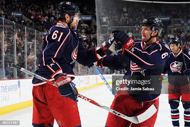 Rick Nash of the Columbus Blue Jackets is congratulated by teammate Anton Stralman after Nash scored the game-winning goal against the Tampa Bay...