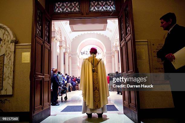 Milwaukee Archbishop Jerome Listecki stands at the back of the Cathedral of St. John the Evangelist after the evening Chrism Mass March 30, 2010 in...