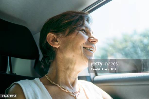 close-up of senior woman in a car - 60 carat stock pictures, royalty-free photos & images