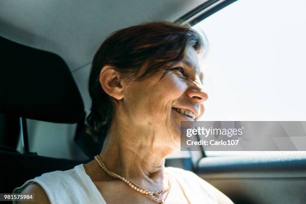 close-up of senior woman in a car - 60 carat stock pictures, royalty-free photos & images