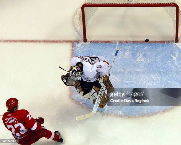 Brad Stuart of the Detroit Red Wings scores the game-winning goal on Jeff Deslauriers of the Edmonton Oilers during an NHL game at Joe Louis Arena on...