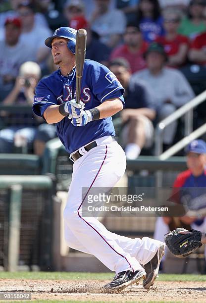 Jarrod Saltalamacchia of the Texas Rangers bats against the Cleveland Indians during the MLB spring training game at Surprise Stadium on March 19,...