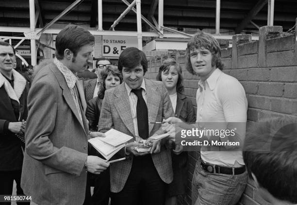English footballer Rodney Marsh pictured on right signing autographs with Terry Venables as he re-visits his old club, Queens Park Rangers at Loftus...