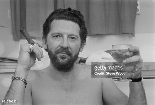 American musician and singer Jerry Lee Lewis pictured with cigar and drinking glass backstage at the Palladium in London on 24th April 1972.