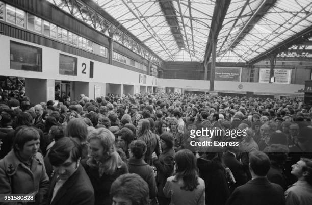 View of commuters and passengers crowded on to the concourse as they wait for delayed and cancelled British Rail Southern Region trains at Charing...