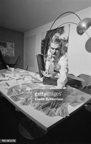 Welsh actor Stanley Baker pictured with a suitcase full of tickets for the upcoming Great Western Express Festival, London, 6th May 1972. Stanley...