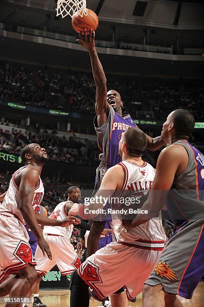 Jason Richardson of the Phoenix Suns takes the ball to the basket as Ronald Murray of the Chicago Bulls watches from the side during the NBA game on...