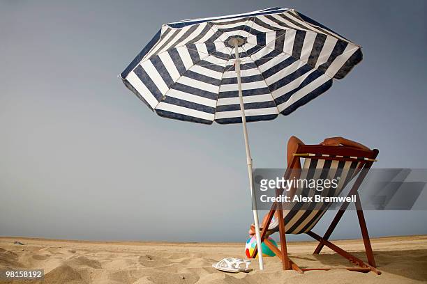 relaxing on the beach - parasol stockfoto's en -beelden