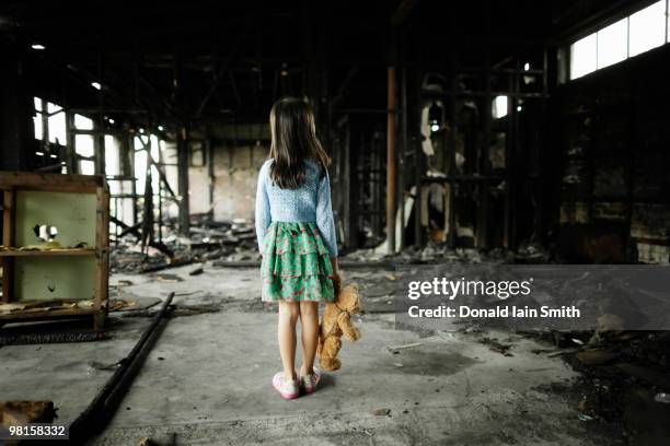 girl with teddy bear in burned building - girl from behind stock pictures, royalty-free photos & images