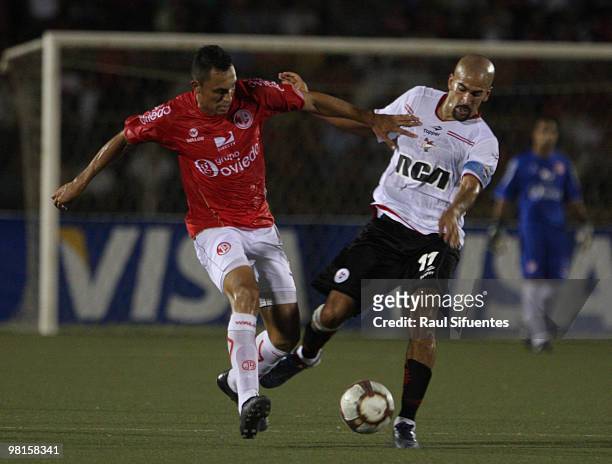 Player Juan Sebastian Veron of Estudiantes vies for the ball with Gianfranco Espejo of Juan Aurich during their match as part of the 2010...