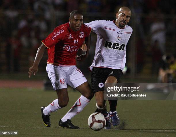 Player Juan Sebastian Veron of Estudiantes vies for the ball with Roberto Guizasola of Juan Aurich during their match as part of the 2010...