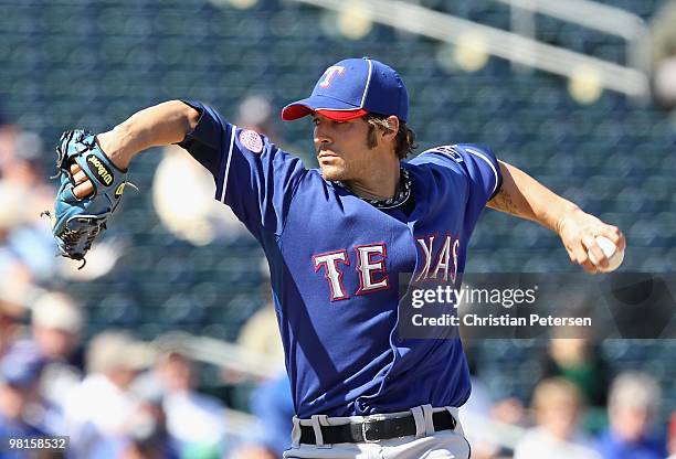 Relief pitcher C.J. Wilson of the Texas Rangers pitches against the Kansas City Royals during the MLB spring training game at Surprise Stadium on...