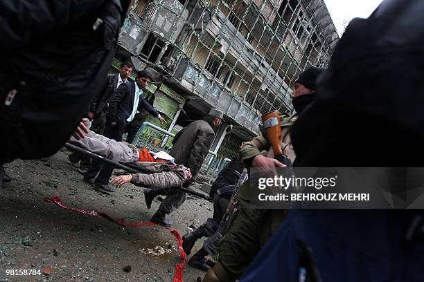 Afghanistan-unrest-India, FOCUS by Lynne O'Donnell In this February 26, 2010 photograph, Afghan security personnel carry an injured man on a...