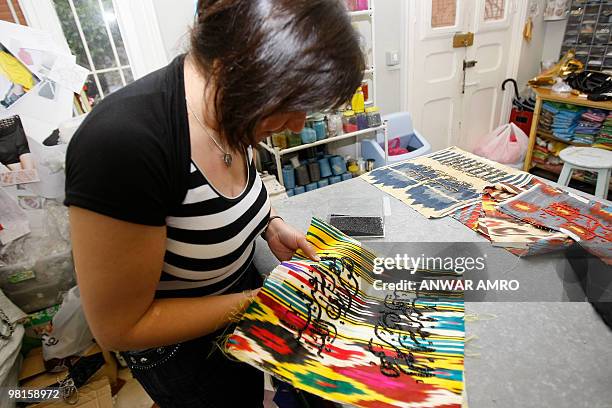 Former inmate Najwa works on a handmade handbag for the label Sarah's Bags in Beirut on March 24, 2010. The brainchild and namesake of Lebanese...