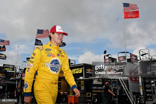 Todd Gilliland, driver of the Royal Canin Toyota, walks through the garage during practice for the NASCAR Camping World Truck Series Villa Lighting...