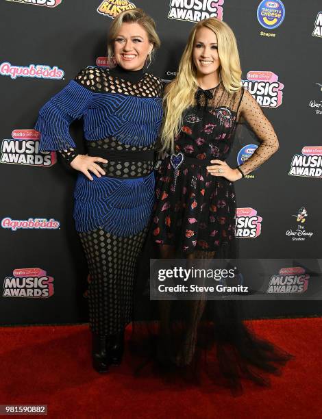 Kelly Clarkson, Carrie Underwood arrives at the 2018 Radio Disney Music Awards at Loews Hollywood Hotel on June 22, 2018 in Hollywood, California.