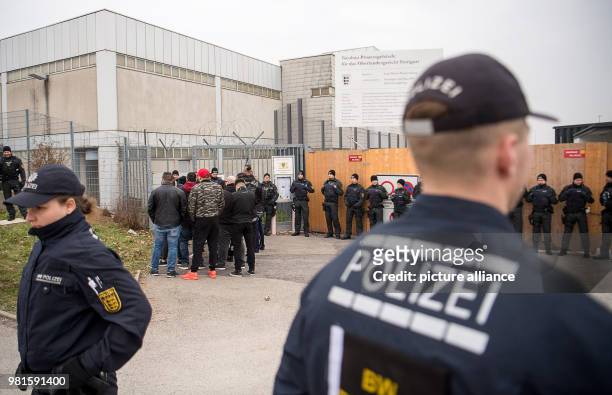 March 2018, Germany, Stuttgart: Visitors standing at the entrance to the court before the start of the trial against alleged leader of the Turkish...