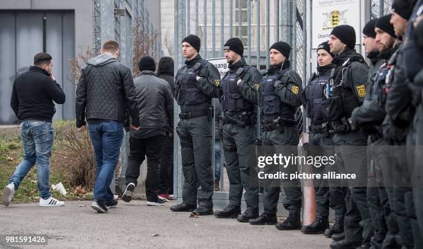 March 2018, Germany, Stuttgart: Visitors standing at the entrance to the court before the start of the trial against alleged leader of the Turkish...