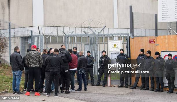 March 2018, Germany, Stuttgart: Visitors standing at the entrance to the court before the start of the trial against alleged leader of the Turkish...