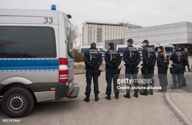 March 2018, Germany, Stuttgart: Police officers standing at the entrance to the court before the start of the trial against alleged leader of the...