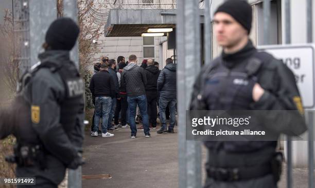 Dpatop - 26 March 2018, Germany, Stuttgart: Visitors standing at the entrance to the court before the start of the trial against alleged leader of...