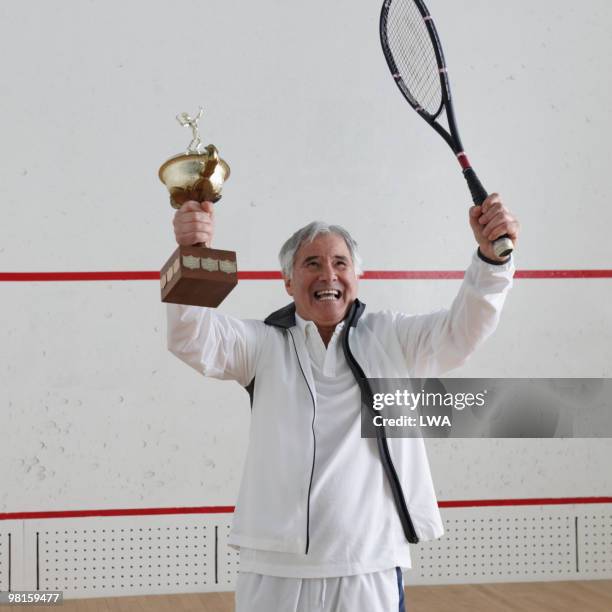 excited senior, arms raised, with trophy  - holding trophy stock pictures, royalty-free photos & images