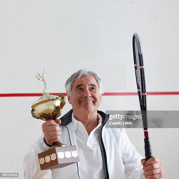 senior man holding trophy, looking up - trophy wall stock pictures, royalty-free photos & images