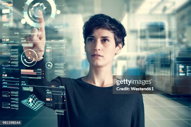 young woman using transparent touchscreen display, composing - durchsichtig kleidung frau stock-fotos und bilder