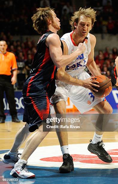 Marcelinho Huertas, #9 of Caja Laboral competes with Zoran Planinic, #34 of CSKA Moscow during the Euroleague Basketball 2009-2010 Play Off Game 3...